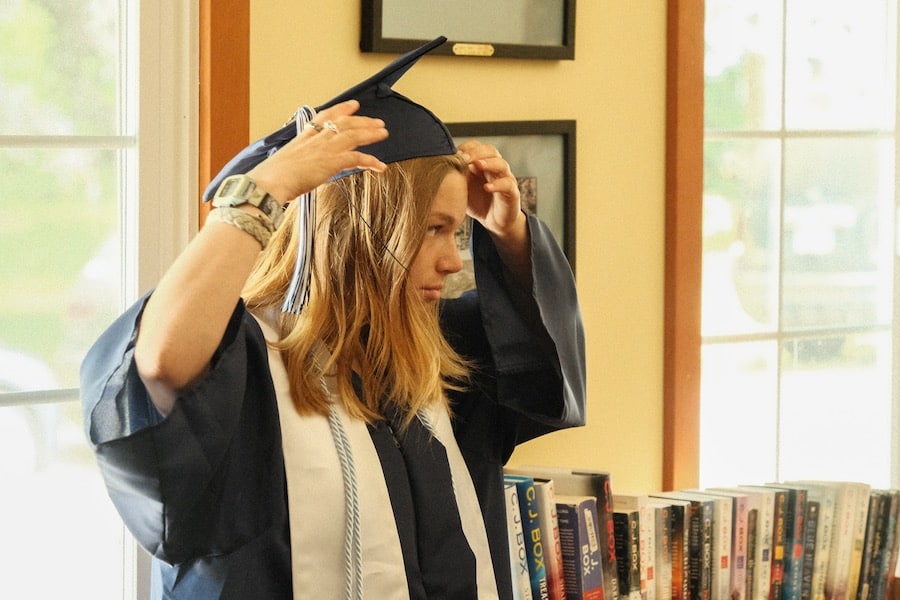 LC adjusts her cap before the graduates walk for graduation