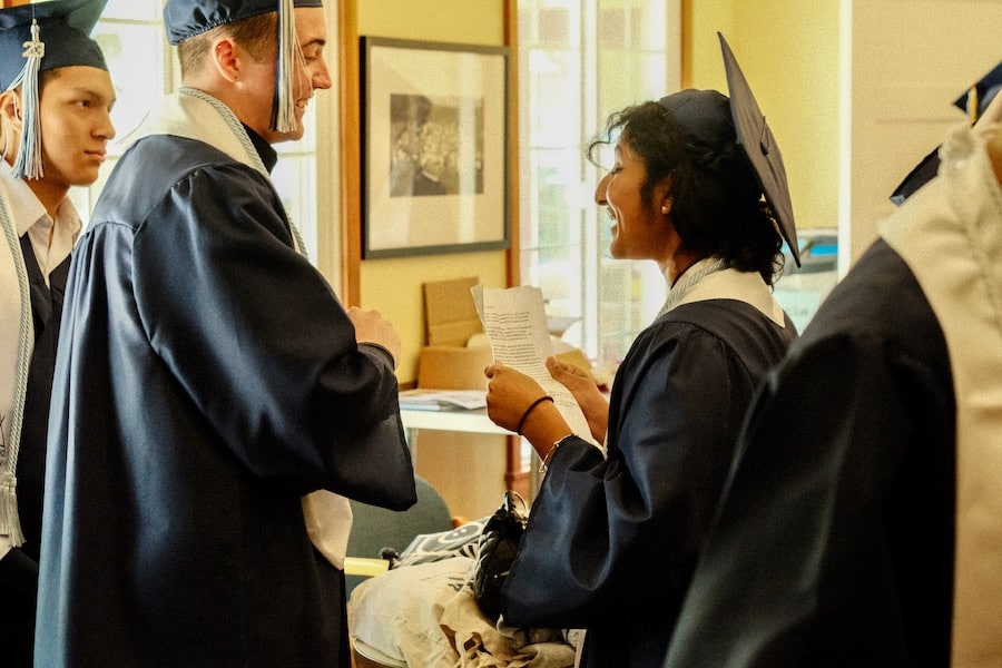 The graduates get ready to walk in the Indianola Clubhouse library