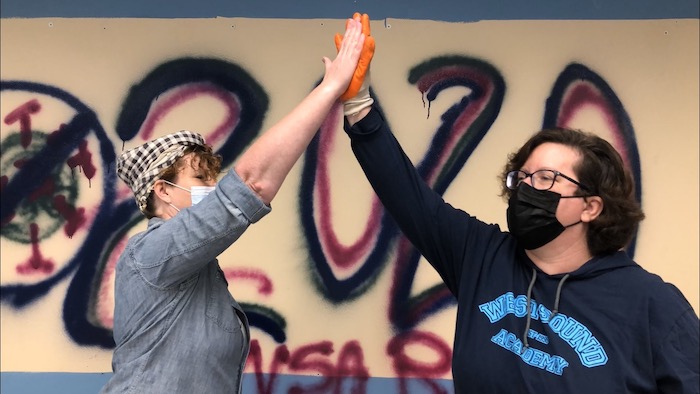 Barrie and Lisa give high fives during the tear-down project