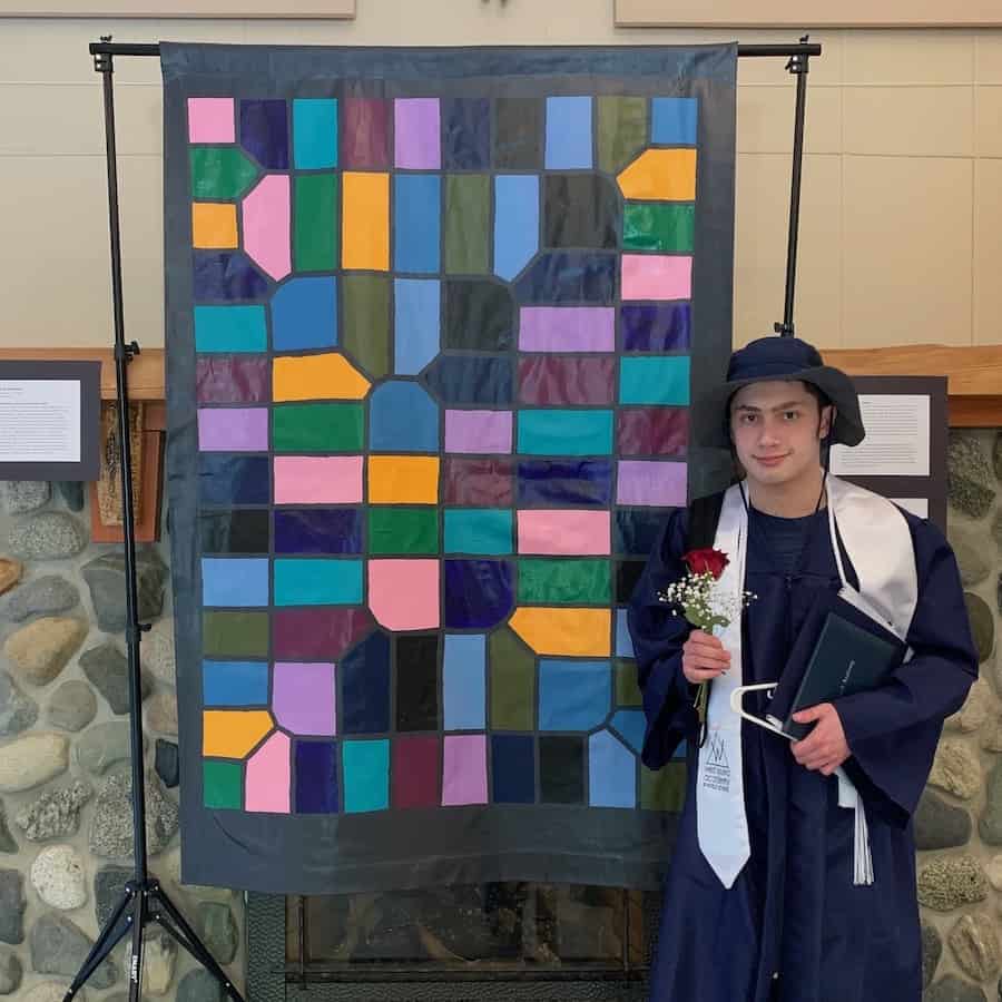 Chayton Martinez at graduation with his math mural