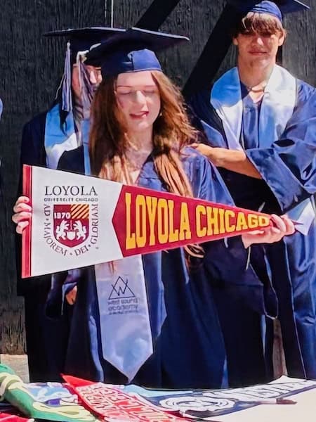 Merryn holding her college pennant on Declaration Day, May 27, 2026
