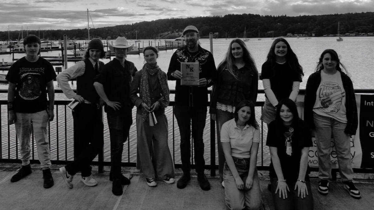 Paul and his North Kitsap Teacher of the Year award with some of his June Tunes students at Liberty Bay Park on June 9, 2026